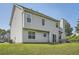 Two story home exterior featuring light gray vinyl siding, windows, and backyard at 3370 Flagstone Trce, Ellenwood, GA 30294