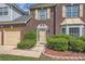 Close-up of the front door with brick facade and manicured landscaping and flower bed at 3370 Flagstone Trce, Ellenwood, GA 30294