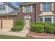 Close-up of the front door with manicured shrubs and mulched flower beds at 3370 Flagstone Trce, Ellenwood, GA 30294