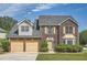 Charming two-story brick home with a manicured lawn, attached two-car garage, and welcoming curb appeal at 3370 Flagstone Trce, Ellenwood, GA 30294
