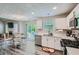 Well-lit open kitchen with updated appliances, white cabinetry, and a view to the outdoor patio at 3370 Flagstone Trce, Ellenwood, GA 30294