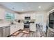 Modern kitchen featuring stainless steel appliances, white cabinetry, and sleek countertops at 3370 Flagstone Trce, Ellenwood, GA 30294