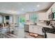 Well-lit kitchen with stainless steel appliances, white cabinets, and backyard access at 3370 Flagstone Trce, Ellenwood, GA 30294