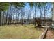 Spacious backyard featuring a barn, a deck, and a well-maintained lawn offering endless possibilities for outdoor activities at 4312 Daniel Dr, Winston, GA 30187