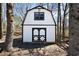 White barn featuring black trim, offering a versatile space perfect for storage or a workshop in a tranquil setting at 4312 Daniel Dr, Winston, GA 30187
