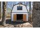 White barn featuring black trim, offering a versatile space perfect for storage or a workshop in a tranquil setting at 4312 Daniel Dr, Winston, GA 30187