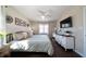 Cozy bedroom with a decorative headboard, ceiling fan, and a large window for natural light at 4312 Daniel Dr, Winston, GA 30187