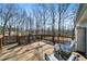 Relaxing deck area with wooden railing, outdoor seating, and a view of the peaceful wooded surroundings at 4312 Daniel Dr, Winston, GA 30187