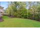 A well-manicured backyard featuring lush green grass and a wrought iron fence at 4827 Basingstoke Dr, Suwanee, GA 30024
