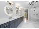 Modern bathroom with dual sinks, backlit mirrors, and a glass-enclosed shower with marble tile at 4827 Basingstoke Dr, Suwanee, GA 30024