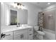 Bright bathroom featuring a modern vanity, neutral color palette, and tub/shower combination at 4827 Basingstoke Dr, Suwanee, GA 30024