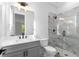 Modern bathroom featuring marble tile shower, gray vanity, and sleek fixtures at 4827 Basingstoke Dr, Suwanee, GA 30024