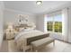 Bright bedroom with large window, neutral decor, and comfortable furnishings at 4827 Basingstoke Dr, Suwanee, GA 30024