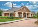 Elegant clubhouse with brick facade, manicured landscaping, and ample parking at 4827 Basingstoke Dr, Suwanee, GA 30024