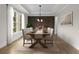 Formal dining room with hardwood floors, tray ceiling, and elegant table setting at 4827 Basingstoke Dr, Suwanee, GA 30024