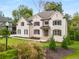 Elegant two-story brick home with a manicured lawn and a paved walkway at 4827 Basingstoke Dr, Suwanee, GA 30024