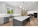 Kitchen featuring a center island with quartz countertop, white cabinetry and stainless appliances at 4827 Basingstoke Dr, Suwanee, GA 30024