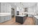 This kitchen features white cabinets, stainless steel appliances, and a large center island, perfect for cooking and entertaining at 4827 Basingstoke Dr, Suwanee, GA 30024