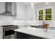 Modern kitchen with white cabinets, stainless steel appliances, and marble countertops at 4827 Basingstoke Dr, Suwanee, GA 30024
