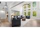 A living room with tall ceilings, hardwood floors, recessed lighting, and lots of windows at 4827 Basingstoke Dr, Suwanee, GA 30024