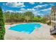 Outdoor pool area featuring lounge chairs and a beautiful tree-lined backdrop at 4827 Basingstoke Dr, Suwanee, GA 30024