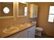 Bathroom with dual sinks, cabinet storage, and a separate toilet area at 59 Pine Ridge Ln, White, GA 30184