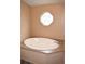 Bathroom featuring a large oval soaking tub under an octagonal window at 59 Pine Ridge Ln, White, GA 30184