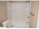 Compact bathroom features a tub-shower combination with white tile and a modern toilet at 59 Pine Ridge Ln, White, GA 30184