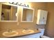 Well-lit bathroom featuring dual sinks, modern faucets, and a storage cabinet at 59 Pine Ridge Ln, White, GA 30184