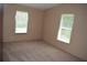 Neutral bedroom with carpet, two windows and base molding at 59 Pine Ridge Ln, White, GA 30184