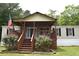 Charming single Gathering home with covered front porch and flower beds in the front yard at 59 Pine Ridge Ln, White, GA 30184
