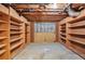 Unfinished basement features built in shelving and exposed pipes and ceilings at 1095 Willow Bnd, Roswell, GA 30075