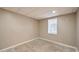 Unfinished basement with concrete floors and natural light from a window at 1095 Willow Bnd, Roswell, GA 30075