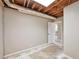 Unfinished basement with exposed ceiling, concrete floor, and a doorway into another room at 1095 Willow Bnd, Roswell, GA 30075