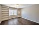 Bedroom with hardwood floors, built-in bookshelves, and a large window at 1095 Willow Bnd, Roswell, GA 30075