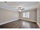 Comfortable bedroom featuring hardwood floors, neutral walls, and a ceiling fan, offering a relaxing retreat at 1095 Willow Bnd, Roswell, GA 30075