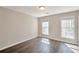 This room features hardwood floors and two windows with natural light at 1095 Willow Bnd, Roswell, GA 30075