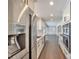 Modern galley kitchen with stainless steel appliances, white cabinetry, and hardwood floors throughout at 1095 Willow Bnd, Roswell, GA 30075