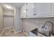 Functional laundry room with cabinets, utility sink, and space for storage, perfect for simplifying household chores at 1095 Willow Bnd, Roswell, GA 30075