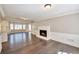 Bright living room features a fireplace, hardwood floors, and large windows that provide natural light at 1095 Willow Bnd, Roswell, GA 30075