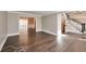 Open living room boasts hardwood floors, neutral paint, and elegant trim work, seamlessly connecting to other living spaces at 1095 Willow Bnd, Roswell, GA 30075