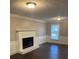 Bright living room features a fireplace, white trim, dark floors, and a large window at 1095 Willow Bnd, Roswell, GA 30075