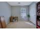 Simple bedroom featuring neutral walls and a large window for natural light at 1527 Ridgewood Sw Dr, Lilburn, GA 30047