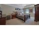 Spacious main bedroom featuring a tray ceiling, chandelier, and elegant furnishings at 1527 Ridgewood Sw Dr, Lilburn, GA 30047