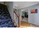 Carpeted staircase with wooden railing leading to an upper level hallway and rooms at 1527 Ridgewood Sw Dr, Lilburn, GA 30047