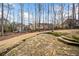 Stone patio and landscaped backyard with mature trees and a peaceful setting at 1904 Rosewood Ln, Woodstock, GA 30189