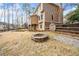 Backyard featuring a stone fire pit and well-manicured lawn at 1904 Rosewood Ln, Woodstock, GA 30189