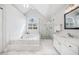 Bright bathroom featuring a soaking tub, glass shower, and marble floors at 1904 Rosewood Ln, Woodstock, GA 30189