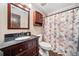 Cozy bathroom featuring a floral shower curtain and wood accents at 1904 Rosewood Ln, Woodstock, GA 30189