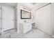 Bathroom featuring marble floors, large vanity with drawers and cabinets, and two entry doors at 1904 Rosewood Ln, Woodstock, GA 30189